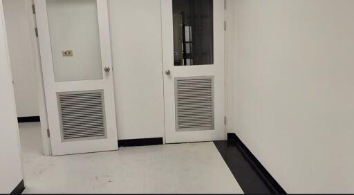 Clean white hallway with doors