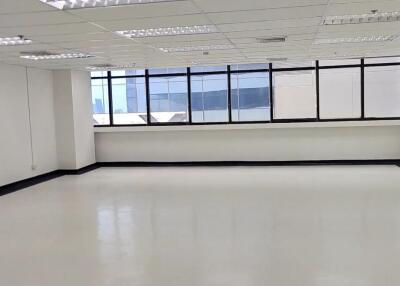 Spacious office area with large windows and ample lighting