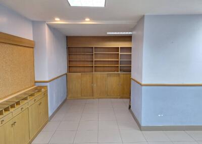 Room with built-in shelves and cabinets