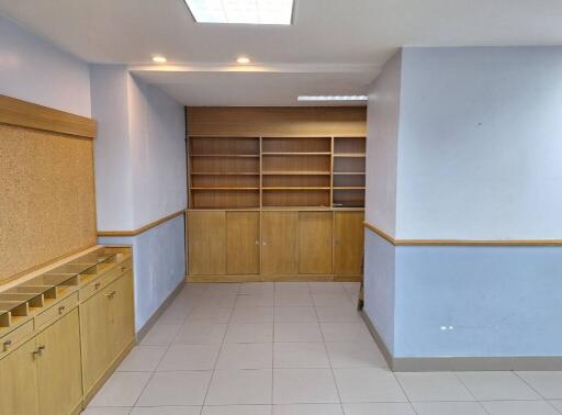 Room with built-in shelves and cabinets