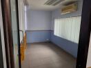 Small room with air conditioner and tiled floor