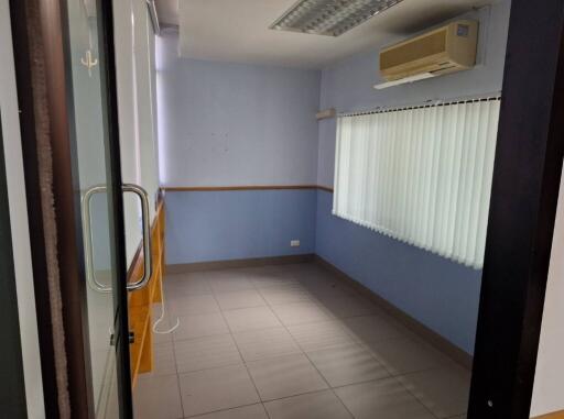 Small room with air conditioner and tiled floor