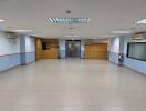 Spacious empty room with tiled flooring and built-in shelves