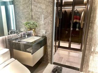 Modern bathroom with walk-in closet entrance