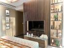 Modern living room with wooden accent wall, wall-mounted TV, and decorative shelving