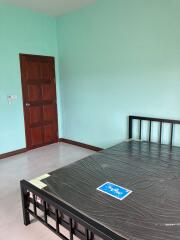 Spacious bedroom with newly painted walls and wooden door