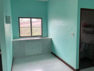 Small kitchen area with a sink and a window