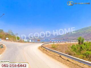 Scenic view of a road with mountains and clear sky