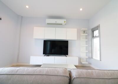 Modern living room with TV and air conditioner