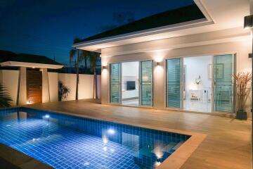 Modern house exterior with pool at night