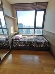 Bedroom with a large window and city view