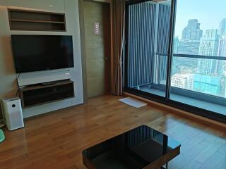 Modern living room with a TV and balcony view