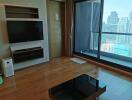 Modern living room with a TV and balcony view