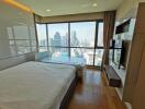 Modern bedroom with large windows offering city view