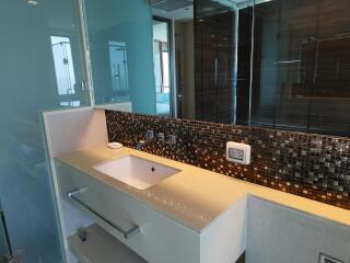 Modern bathroom with a glass wall and mosaic backsplash