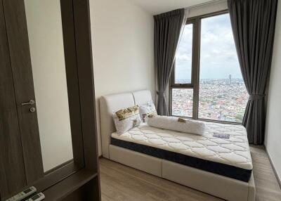 Modern bedroom with large window and city view