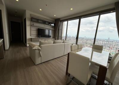 Modern living room with city view and open dining area