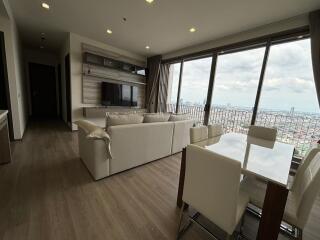 Modern living room with city view and open dining area