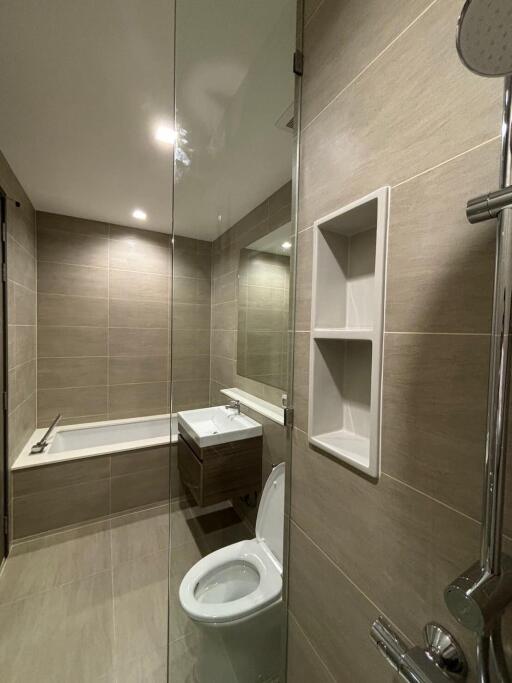 Modern bathroom with bathtub, shower, toilet, and sink