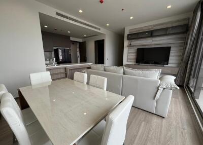 Modern living room with open kitchen and dining area