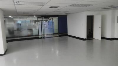 Open office area with glass walls and an open door