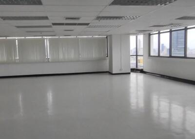 Spacious empty office area with large windows