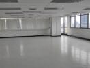 Spacious empty office area with large windows