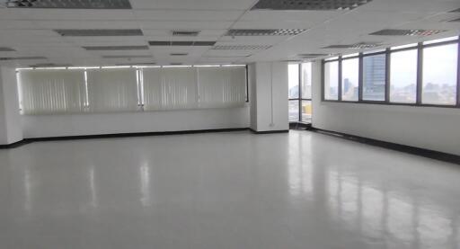 Spacious empty office area with large windows