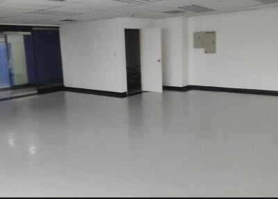 Empty room with white walls and tiled flooring