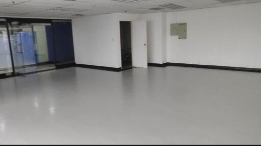 Empty room with white walls and tiled flooring