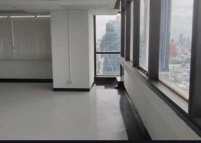 Empty office space with large windows and city view