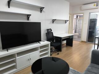 Modern living area with TV and desk setup