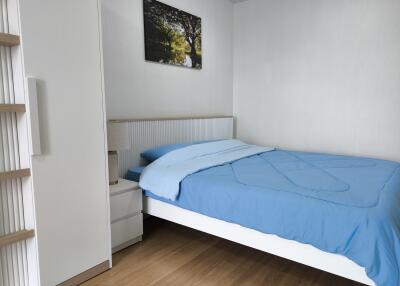 Bedroom with blue bedding and wall art