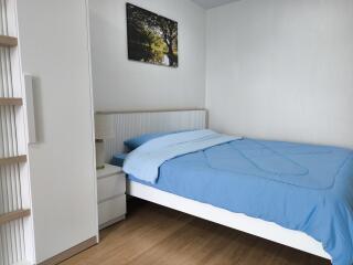 Bedroom with blue bedding and wall art