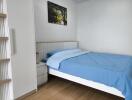 Bedroom with blue bedding and wall art