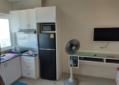 Modern kitchen area with appliances and a small dining/study space