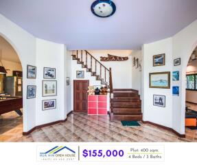 Living area with staircase and framed pictures