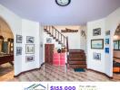 Living area with staircase and framed pictures