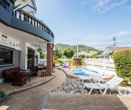 Spacious outdoor area with pool and seating