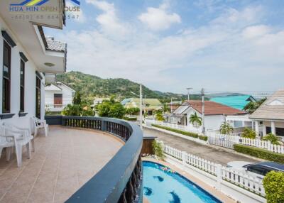 Spacious balcony with a view of the swimming pool and scenic surroundings