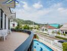 Spacious balcony with a view of the swimming pool and scenic surroundings