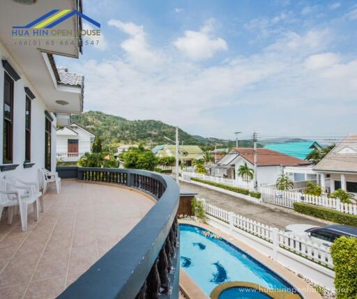 Spacious balcony with a view of the swimming pool and scenic surroundings