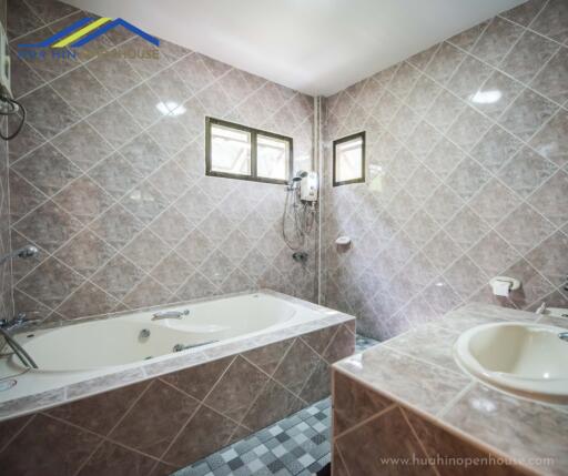 Spacious bathroom with bathtub and sink