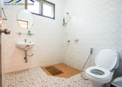 Clean bathroom with white tiles and basic fixtures