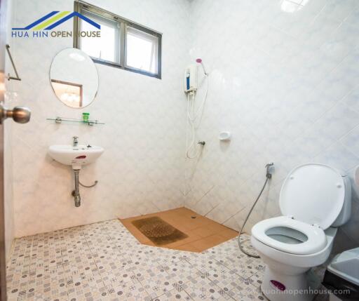 Clean bathroom with white tiles and basic fixtures