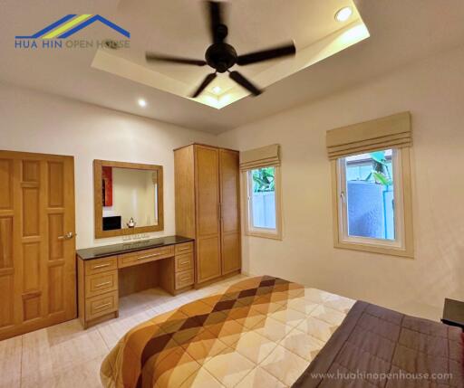 Bedroom with wooden furniture and ceiling fan