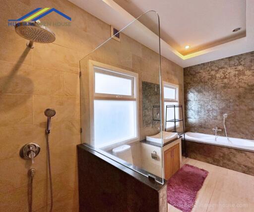 Spacious bathroom with a large bathtub and shower area