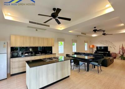 Modern open-plan kitchen and living area with island and dining table