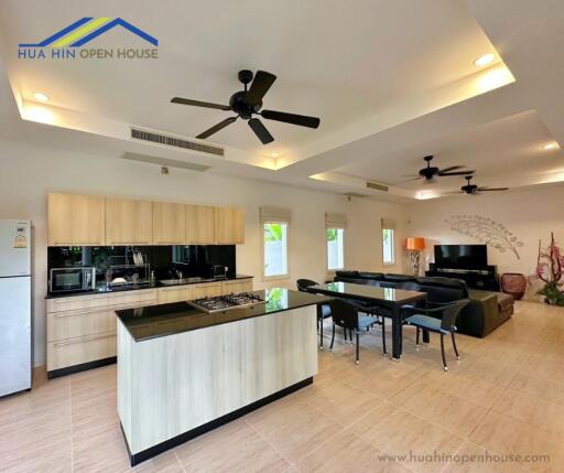 Modern open-plan kitchen and living area with island and dining table