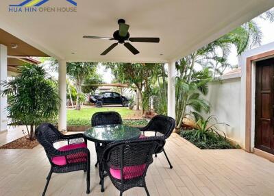 Covered outdoor patio with table and chairs